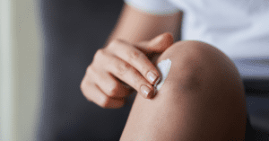 Person using CBD cream for knee pain