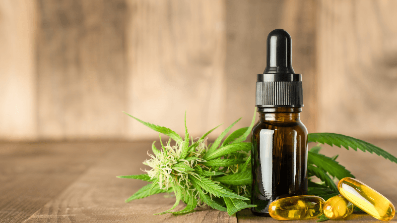 CBD oil bottle, capsules, and hemp flower comparing CBD oil vs. CBD capsules