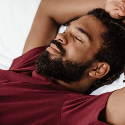 A black man peacefully sleeping.