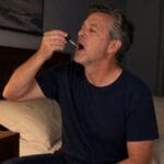 50-year-old man taking Western MA Hemp full-spectrum CBD oil before bed